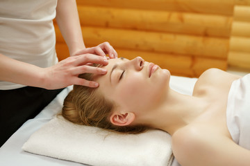 Caring about beauty. Facial massage in spa salon