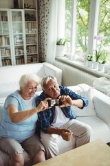 Wall Mural - Senior couple taking a photo from mobile phone