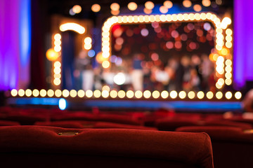 Empty Theater Chairs And Blurred Stage Lights