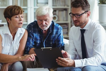 Wall Mural - Senior couple planning their investments with financial advisor