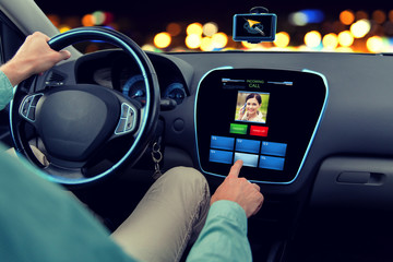 close up of man driving car and receiving call