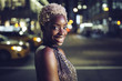 © Westend61 - USA, New York City, portrait of happy young woman on Times Square at night