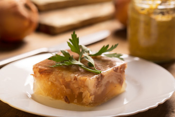 Jellied meat on a brown wooden background