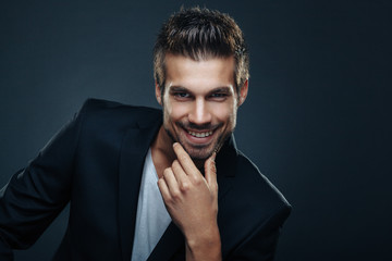 Portrait of handsome man in a studio on a dark background