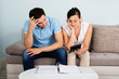 Unhappy Couple Calculating Bills