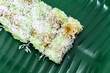 Traditional local green homemade dessert (Putu Bambu) with coconut shredded  on banana leaf plate