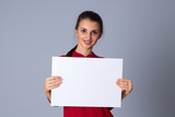 Fototapeta  - Woman holding white sheet of paper