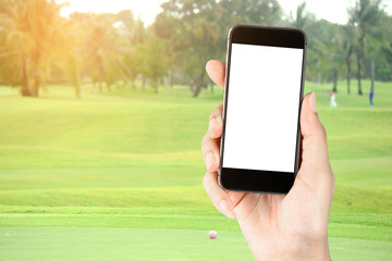 Touch screen in hand, tablet on golf club - soft blur background