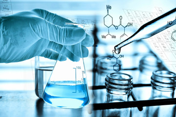 Wall Mural - flask in scientist hand with test tubes in laboratory