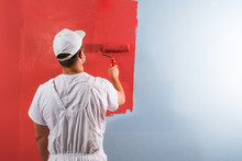 Man Painting Wall With Roller