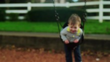 Adorable Little Boy On A Swing In Slow Motion, With A Big Smile On His Face