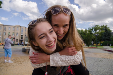 Two girlfriends are having fun walking 