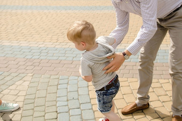 Small baby boy is having fun with his father