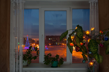 Window from the homely room to the New Year winter