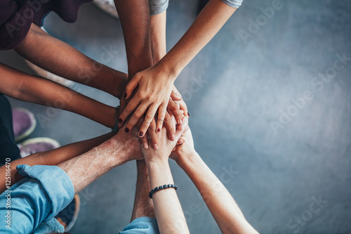Fotografía Stack of hands showing unity and teamwork