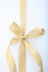 Wall Mural - gold ribbon and bow on white background