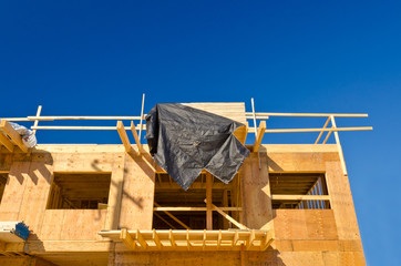 fragment of a new home under construction over blue sky in Vancouver, Canada.