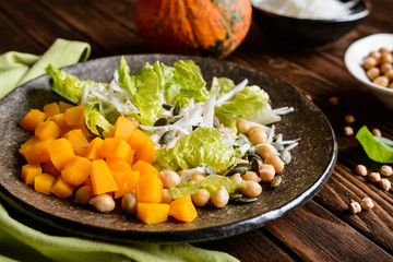 Wall Mural - Pumpkin salad with chickpeas, radish, lettuce and seeds
