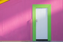 Green White Wooden Door And Pink Wall In Sunlight
