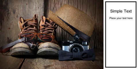 Wall Mural - Vintage boots, hat and accessories for travel on a wooden background with black space for text