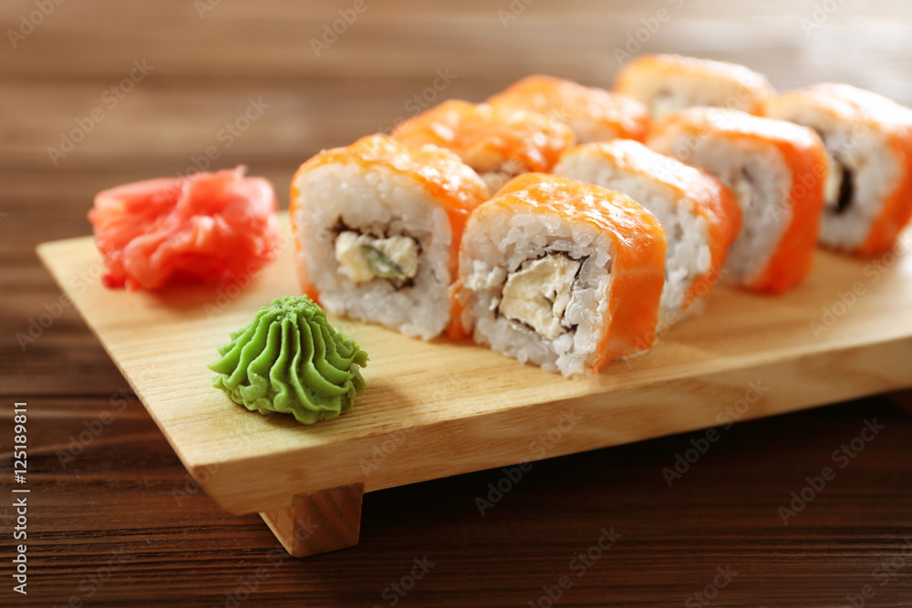 Delicious sushi set on wooden board