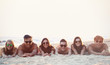 Happy friends lying on beach sand