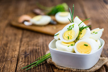 Halved Eggs On Wooden Background