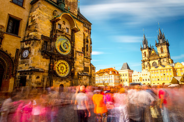 Wall Mural - View on the astronomical clock and cathedral on the old town square in Prague city. Long exposure image technic with blurred people and clouds
