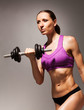 © Sergey Novikov - Young slim woman hold dumbbell with strong look