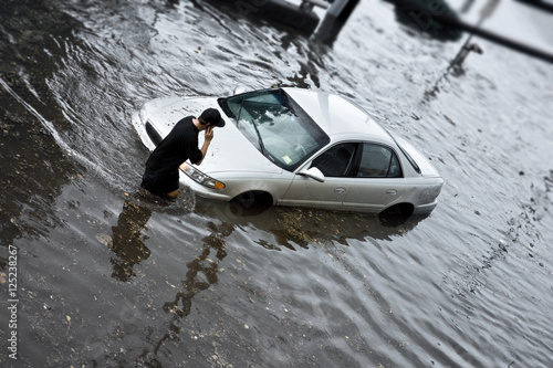 Fotografie, Obraz Flood Insurance concept image with unrecognizable person stuck in flood waters