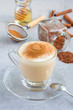 Healthy rooibos red tea latte topped with cinnamon, vertical