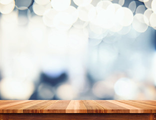 Empty perspective wood plank table top with abstract bokeh light