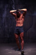 © ArtFamily - Muscular macho man with perfect abs posing in studio