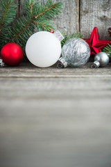 Wall Mural - red, silver and white xmas ornaments on rustic wood background. merry christmas card. winter holiday