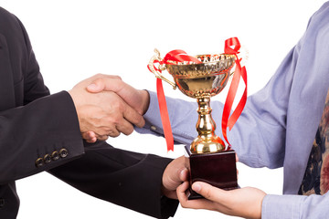 asian business man shake hand and receive golden trophy