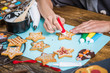 © marcin jucha - woman decorating gingerbread Christmas cookies