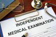 © Vitalii Vodolazskyi - Independent Medical Examination (IME) form on a wooden table.