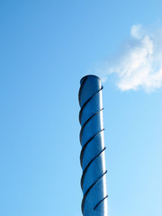 Wall Mural - Steel smoking stack of the modern boiler-house against a blue sk