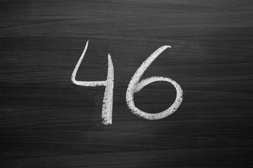 Wall Mural - number forty six enumeration written with a chalk on the blackboard