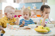 © Andrey Kuzmin - little kids eating in kindergarten