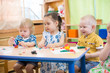 © Andrey Kuzmin - kids doing arts and crafts in day care centre