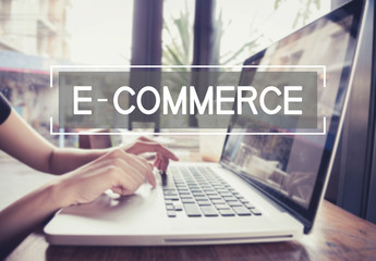 Wall Mural - business hand typing on a laptop keyboard with e-commerce homepage on the computer screen digital em