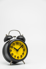 Black vintage retro style alarm clock on white background and selective focus