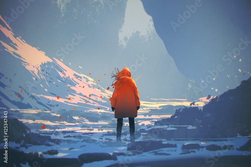 Fotografía rear view of woman with orange warm jacket standing in winter landscape,illustra