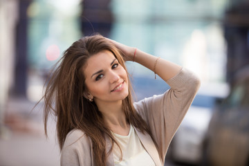 Outdoor portrait of beauty woman with perfect smile walking on the street