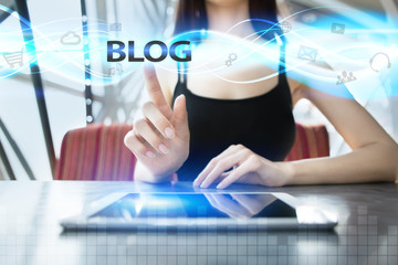 Wall Mural - woman is using tablet pc, pressing on virtual screen and selecting blog