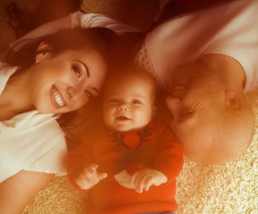 Wall Mural - The happinest mother,father  and  son lie on the bed