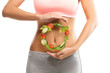 © Tijana - Fit, young woman holding a circle made out of vegetables over her abdomen