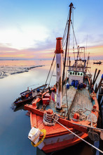 Fishing Boat In A Harbor With Sunset In Holiday