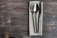 Concept Of Simple Organic Food - Laconic Design Cutlery Set On Rustic Wooden Table And Linen Tissue. Top View.